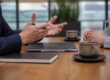 Close-up of an executive coaching plan review across a conference table