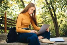Casual female student on laptop creating good habits