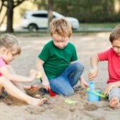 Children play outdoors building a relationship