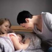 Mother communicating with cheerful daughters