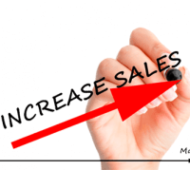Hand writing increase sales with red arrow going up