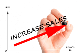 Hand writing increase sales with red arrow going up