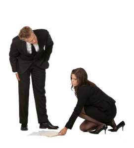 Man looking at woman picking up papers off of the floor